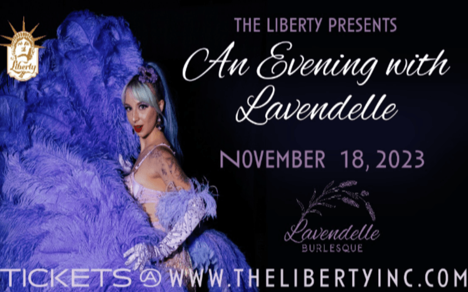 Lavendelle laying on a pile of purple and fluffy material. Pictured to the right is event text for her live music/performance event.