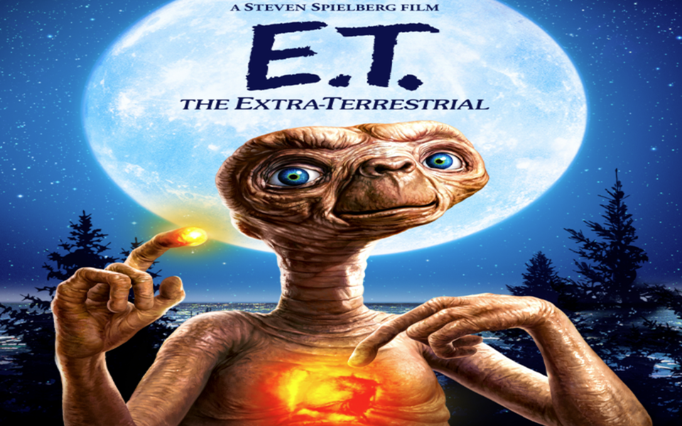 E.T. pictured with a forest and deep blue sky. Includes text describing the movie.